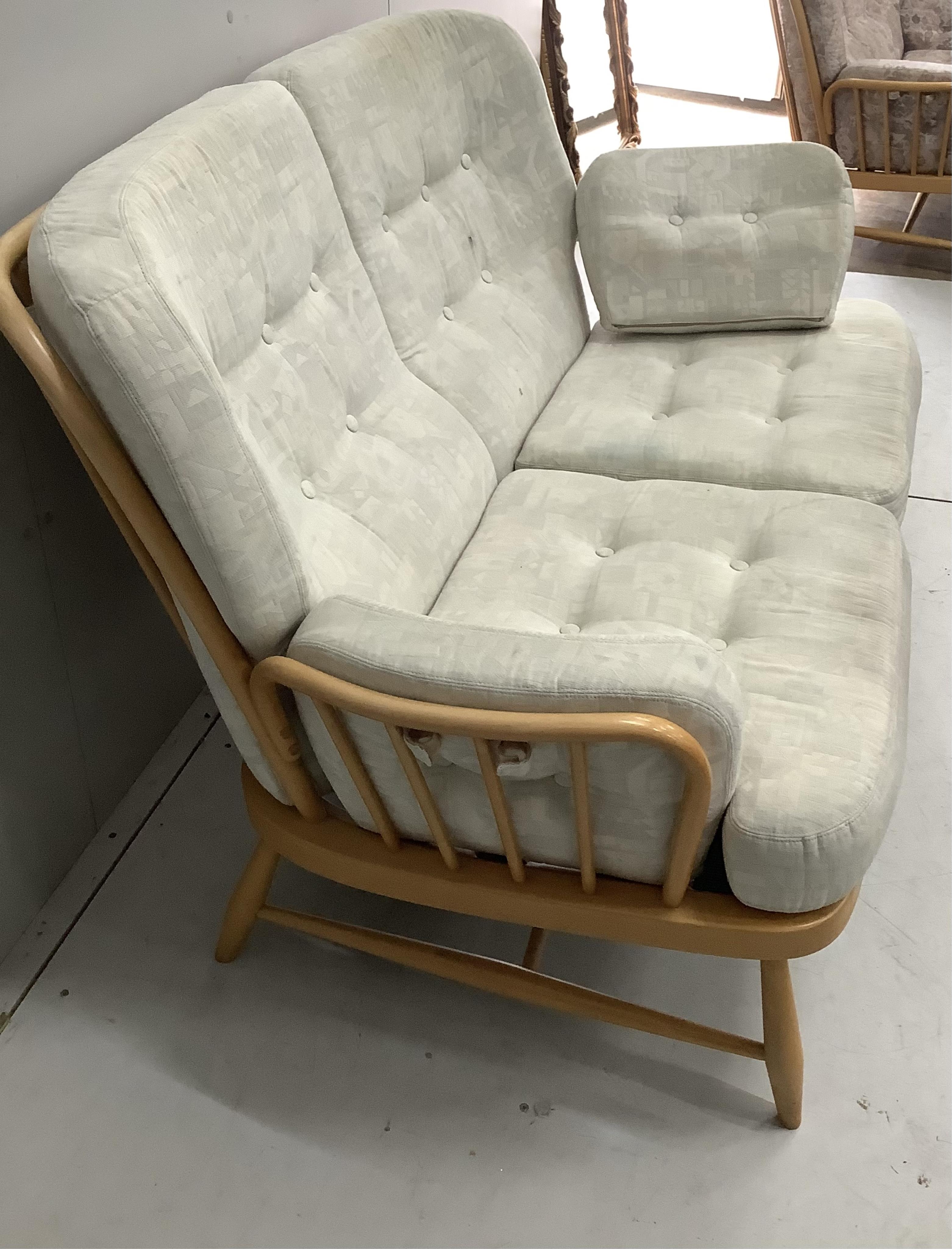 A pair of Ercol beech settees, width 140cm, depth 80cm, height 82cm